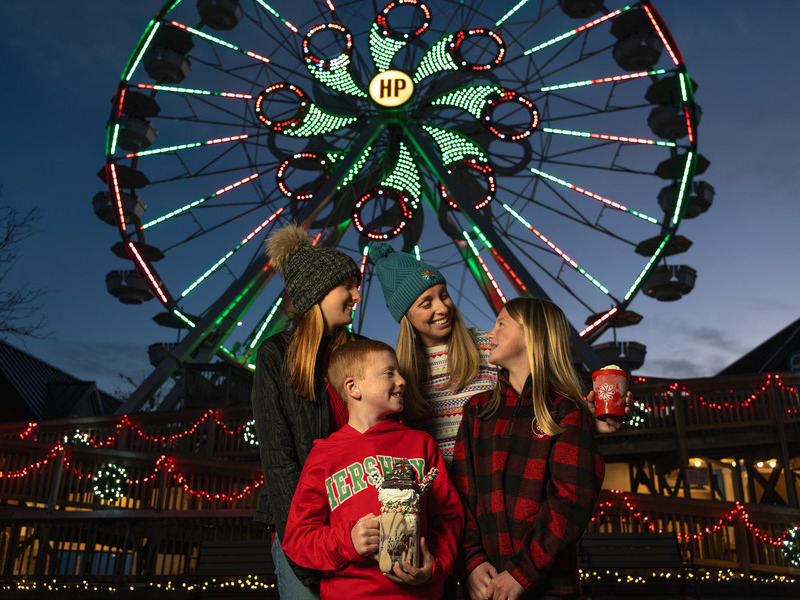 Children with mother on Ferris wheel.