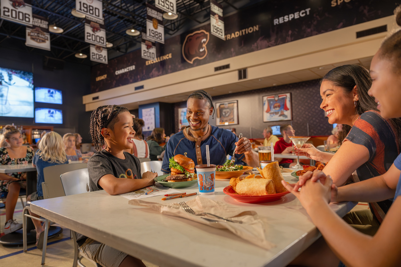Family enjoying a meal by a fireplace